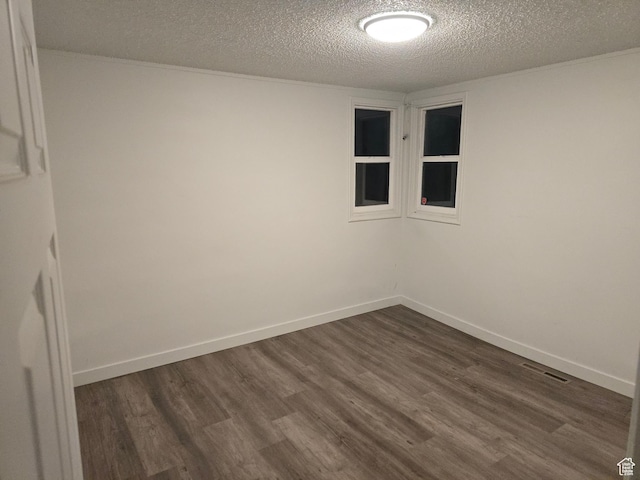 530 E 31st St, Ogden, UT 84403 - empty room featuring a textured ceiling, dark wood finished floors, and baseboards