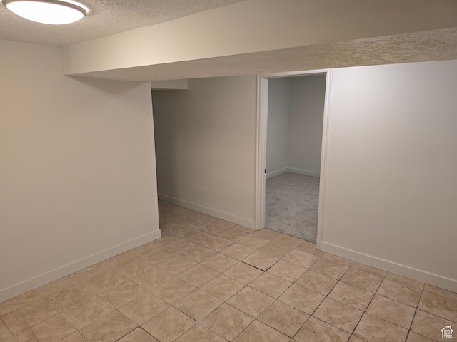 530 E 31st St, Ogden, UT 84403 - finished below grade area with a textured ceiling, light tile patterned flooring, and baseboards