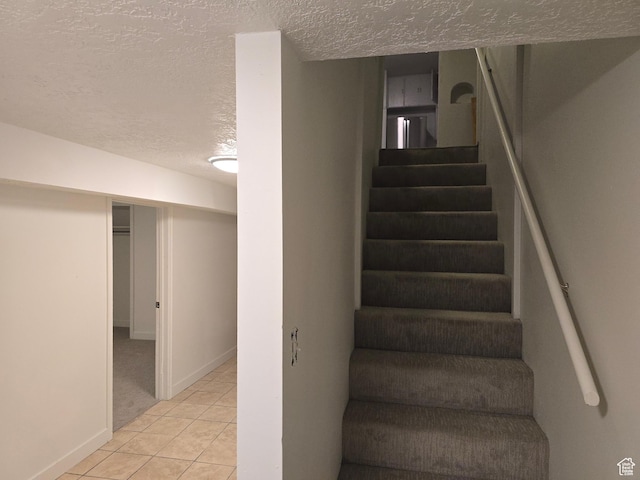 530 E 31st St, Ogden, UT 84403 - stairway with a textured ceiling, tile patterned floors, and baseboards