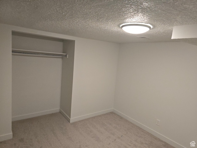 530 E 31st St, Ogden, UT 84403 - unfurnished bedroom with a closet, baseboards, light colored carpet, and a textured ceiling