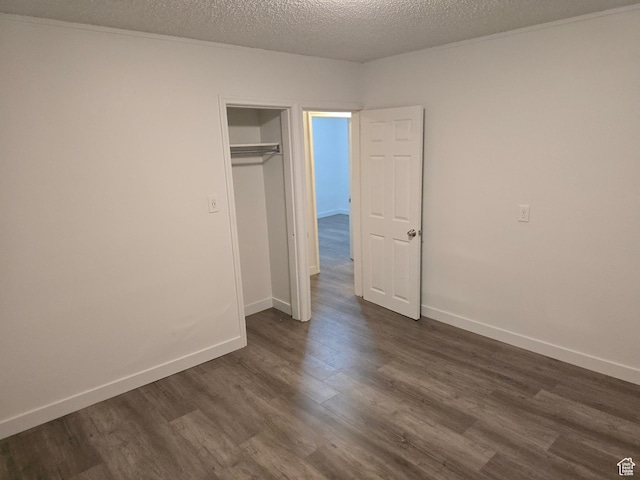530 E 31st St, Ogden, UT 84403 - unfurnished bedroom featuring dark wood-style floors, a textured ceiling, and baseboards
