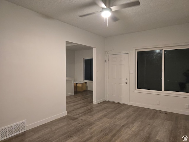530 E 31st St, Ogden, UT 84403 - empty room with dark wood-type flooring, a ceiling fan, a textured ceiling, and baseboards