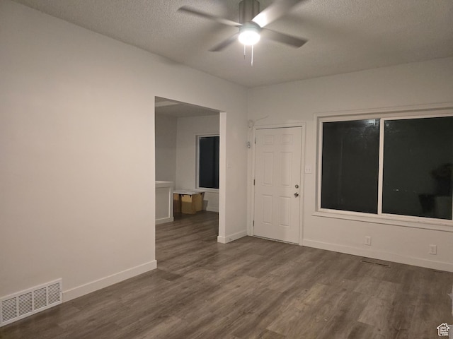 530 E 31st St, Ogden, UT 84403 - empty room featuring dark wood-type flooring, a ceiling fan, a textured ceiling, and baseboards