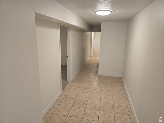 530 E 31st St, Ogden, UT 84403 - corridor featuring a textured ceiling, light tile patterned floors, and baseboards