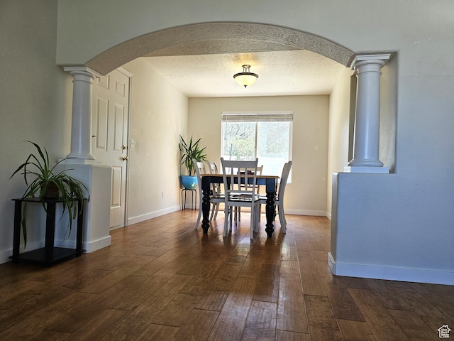 506 E 670 N, Tooele, UT 84074 - dining space with arched walkways, dark wood-style flooring, decorative columns, and baseboards