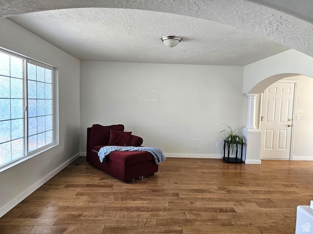 506 E 670 N, Tooele, UT 84074 - sitting room featuring wood finished floors, arched walkways, baseboards, and a textured ceiling