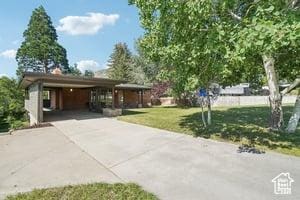3525 E Ceres Dr S, Millcreek, UT 84124 - view of home's community with driveway, a lawn, and an attached carport