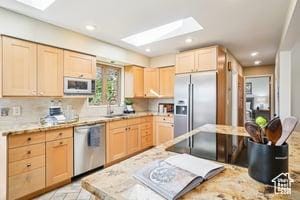 3525 E Ceres Dr S, Millcreek, UT 84124 - kitchen featuring light brown cabinetry, appliances with stainless steel finishes, a skylight, light countertops, and recessed lighting