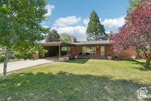 3525 E Ceres Dr S, Millcreek, UT 84124 - view of front of property featuring an attached carport, a front lawn, and driveway