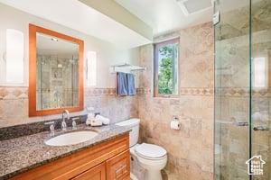 3525 E Ceres Dr S, Millcreek, UT 84124 - bathroom featuring vanity, tile walls, a stall shower, and toilet