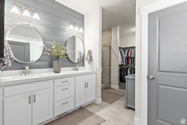 88 N Parkside Loop W, Elk Ridge, UT 84651 - full bath featuring double vanity, tiled shower, a walk in closet, tile patterned floors, and baseboards