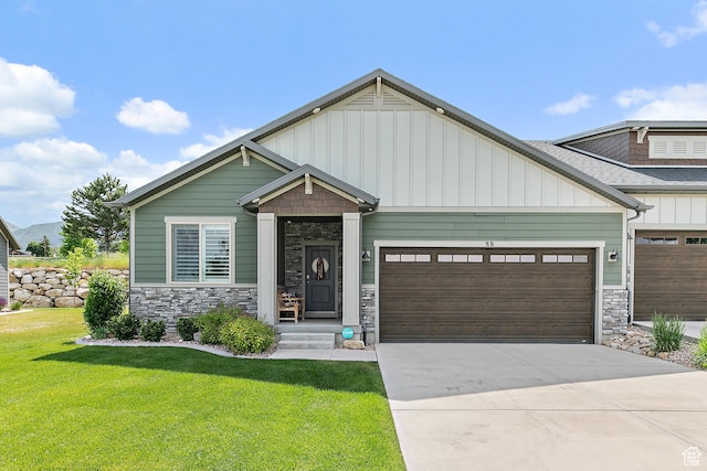 88 N Parkside Loop W, Elk Ridge, UT 84651 - craftsman-style home with stone siding, a front yard, an attached garage, and board and batten siding