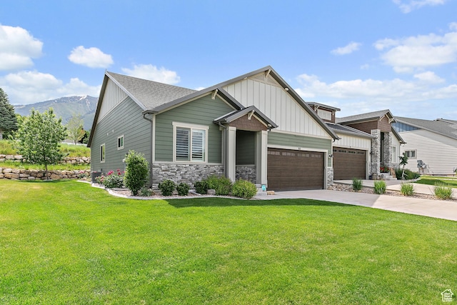88 N Parkside Loop W, Elk Ridge, UT 84651 - craftsman-style house featuring board and batten siding, an attached garage, a front yard, driveway, and stone siding