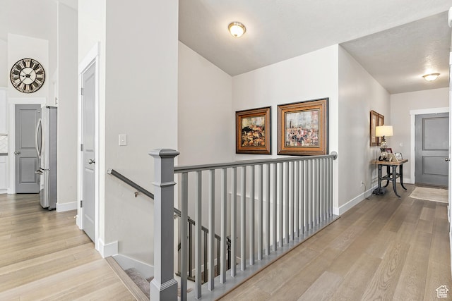 88 N Parkside Loop W, Elk Ridge, UT 84651 - hallway featuring an upstairs landing, light wood finished floors, and baseboards