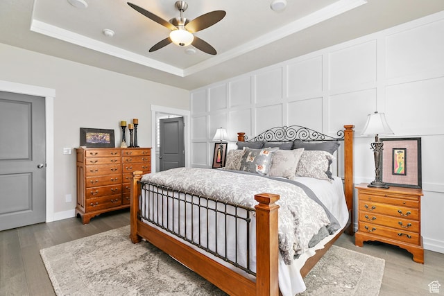 88 N Parkside Loop W, Elk Ridge, UT 84651 - bedroom with a raised ceiling, wood finished floors, ornamental molding, a decorative wall, and a ceiling fan
