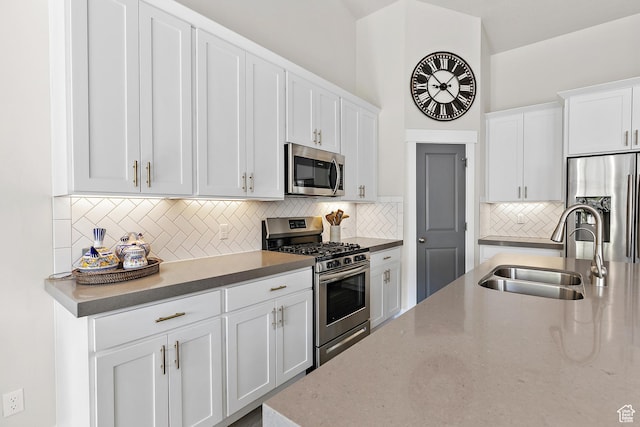 88 N Parkside Loop W, Elk Ridge, UT 84651 - kitchen featuring appliances with stainless steel finishes, a sink, tasteful backsplash, white cabinetry, and light stone counters