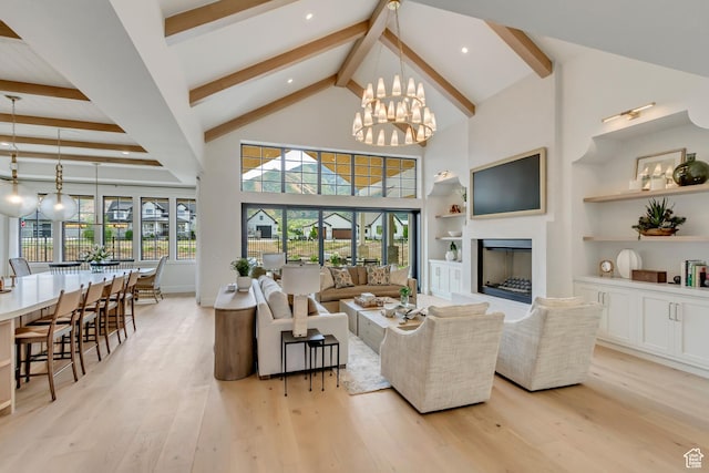423 S 150 E, Mapleton, UT 84664 - living area featuring beamed ceiling, light wood-style flooring, high vaulted ceiling, a chandelier, and a fireplace