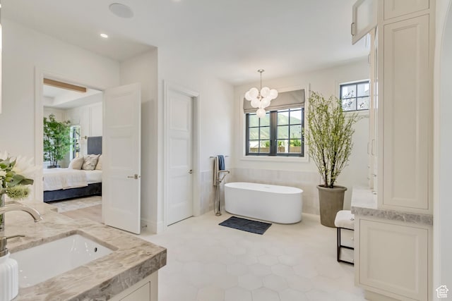 423 S 150 E, Mapleton, UT 84664 - ensuite bathroom featuring double vanity, a freestanding bath, a chandelier, tile patterned floors, and recessed lighting