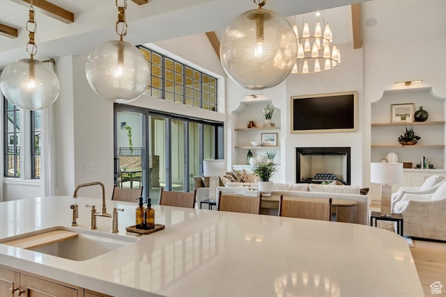 423 S 150 E, Mapleton, UT 84664 - kitchen with built in features, beam ceiling, open floor plan, light countertops, and pendant lighting
