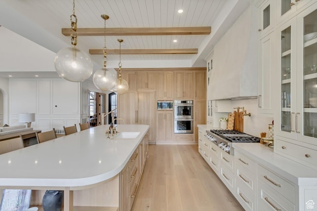 423 S 150 E, Mapleton, UT 84664 - kitchen with appliances with stainless steel finishes, light wood-type flooring, light countertops, open floor plan, and a spacious island
