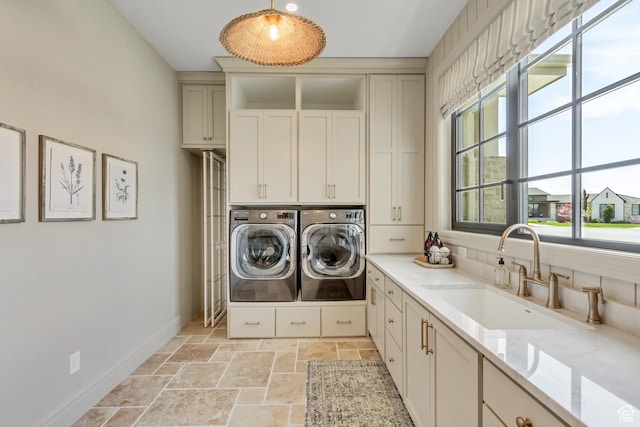 423 S 150 E, Mapleton, UT 84664 - washroom featuring washing machine and dryer, cabinet space, stone tile floors, and healthy amount of natural light