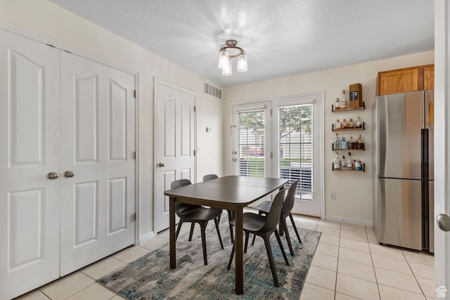 3709 S Angelico Ct Unit D, West Valley City, UT 84119 - dining area featuring light tile patterned flooring, a bar, and baseboards