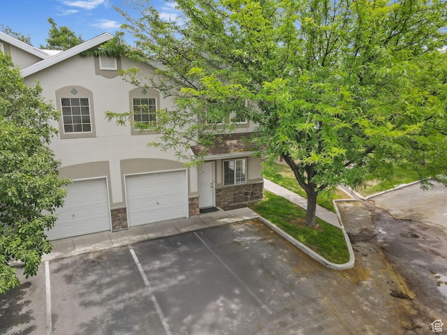3709 S Angelico Ct Unit D, West Valley City, UT 84119 - view of front of property with stone siding, stucco siding, and driveway
