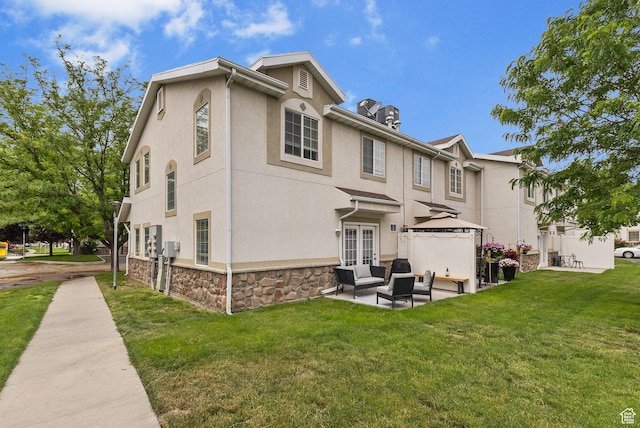 3709 S Angelico Ct Unit D, West Valley City, UT 84119 - rear view of house with an outdoor living space, a gazebo, a yard, and stucco siding