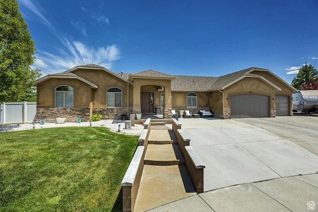 5617 W High Spirit Ct, Herriman, UT 84096 - view of front of house featuring stucco siding, stone siding, an attached garage, concrete driveway, and outdoor lounge area