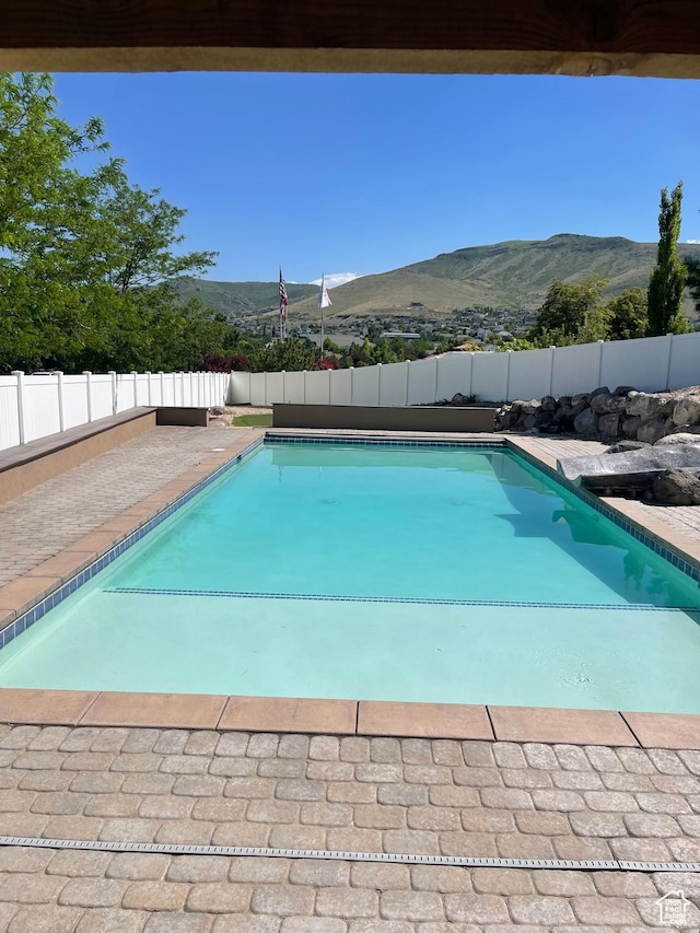 5617 W High Spirit Ct, Herriman, UT 84096 - view of swimming pool with a mountain view and a fenced backyard