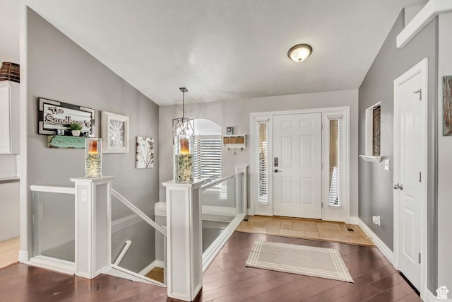 5617 W High Spirit Ct, Herriman, UT 84096 - foyer entrance featuring wood finished floors, lofted ceiling, and a chandelier