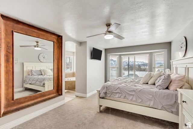 5617 W High Spirit Ct, Herriman, UT 84096 - bedroom featuring light colored carpet, a ceiling fan, connected bathroom, and a textured ceiling