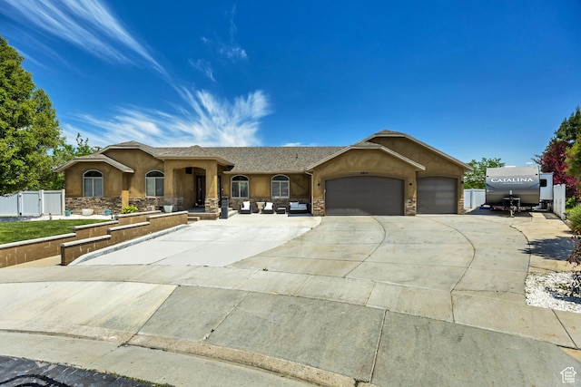 5617 W High Spirit Ct, Herriman, UT 84096 - ranch-style home featuring stucco siding, concrete driveway, an attached garage, and stone siding