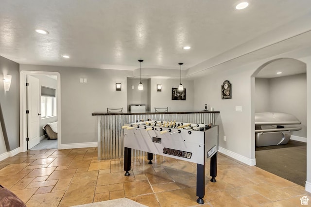 5617 W High Spirit Ct, Herriman, UT 84096 - playroom featuring stone tile floors, recessed lighting, arched walkways, and a dry bar