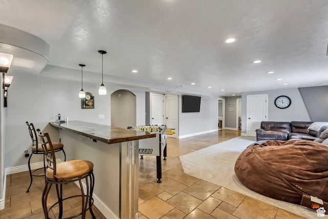 5617 W High Spirit Ct, Herriman, UT 84096 - kitchen featuring a kitchen breakfast bar, arched walkways, recessed lighting, pendant lighting, and a peninsula