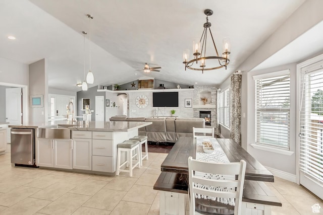 5617 W High Spirit Ct, Herriman, UT 84096 - dining space featuring vaulted ceiling, a chandelier, light tile patterned floors, ceiling fan, and plenty of natural light