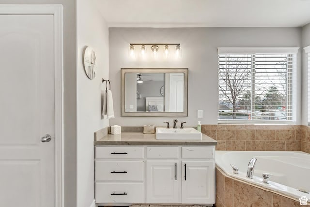 5617 W High Spirit Ct, Herriman, UT 84096 - full bath featuring vanity, a garden tub, and a ceiling fan