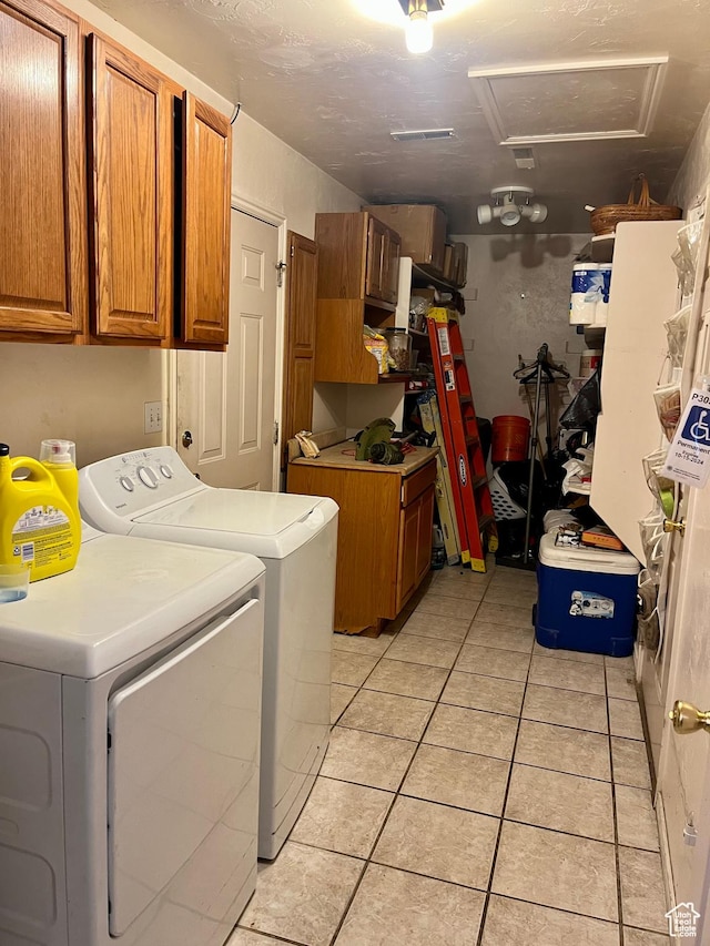 766 Huntridge Dr, Moab, UT 84532 - washroom featuring cabinet space, separate washer and dryer, attic access, and light tile patterned floors