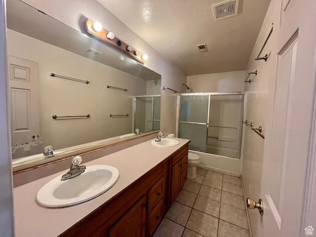 766 Huntridge Dr, Moab, UT 84532 - full bathroom featuring double vanity, tile patterned floors, toilet, and bath / shower combo with glass door