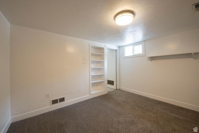 1779 E Ramona Ave S, Salt Lake City, UT 84108 - basement featuring carpet flooring, a textured ceiling, baseboards, and built in shelves
