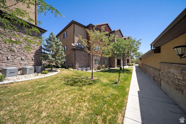 107 E Jordan Blvd Unit 506, Saratoga Springs, UT 84045 - view of grassy yard featuring central air condition unit