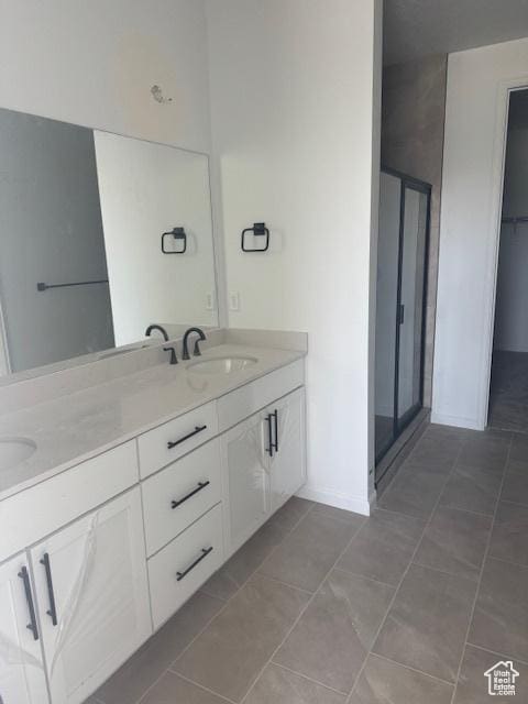 4063 W 2025 S Unit 39, Taylor, UT 84401 - full bathroom with double vanity, tile patterned flooring, a shower stall, and baseboards