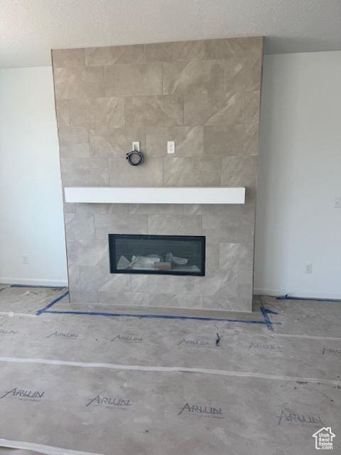 4063 W 2025 S Unit 39, Taylor, UT 84401 - detailed view of a tile fireplace and a textured ceiling