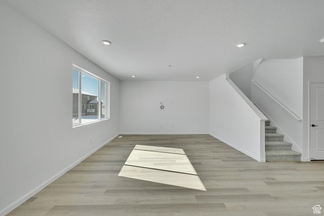 1972 E Burger St Unit 1236, Lake Point, UT 84074 - unfurnished living room featuring recessed lighting, baseboards, light wood-style flooring, and stairs