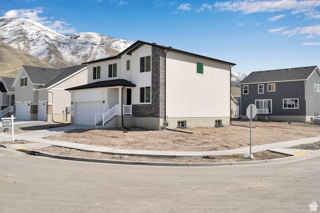 1972 E Burger St Unit 1236, Lake Point, UT 84074 - view of front of home with a mountain view, concrete driveway, and a garage