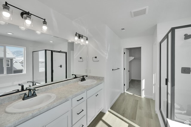 1972 E Burger St Unit 1236, Lake Point, UT 84074 - bathroom featuring a stall shower, wood finished floors, double vanity, and baseboards