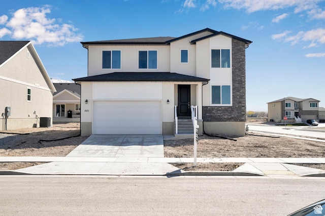 1972 E Burger St Unit 1236, Lake Point, UT 84074 - view of front of house featuring a garage, cooling unit, stucco siding, and driveway