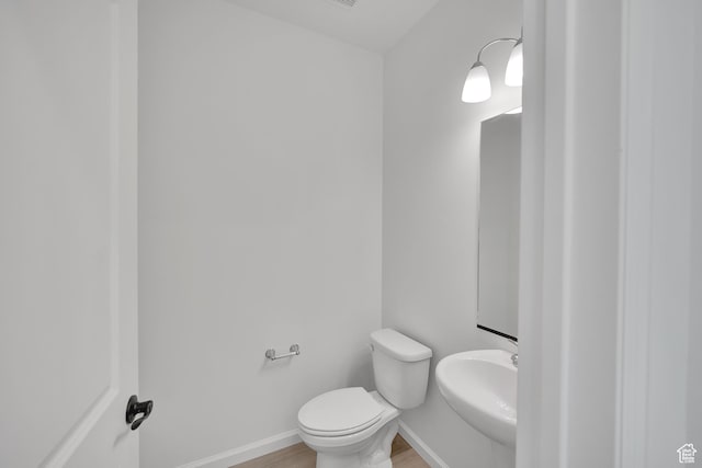 1972 E Burger St Unit 1236, Lake Point, UT 84074 - half bath featuring wood finished floors, toilet, a sink, and baseboards