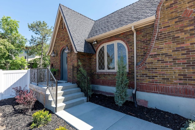 4555 S Highland Dr E, Holladay, UT 84117 - property entrance with roof with shingles and brick siding