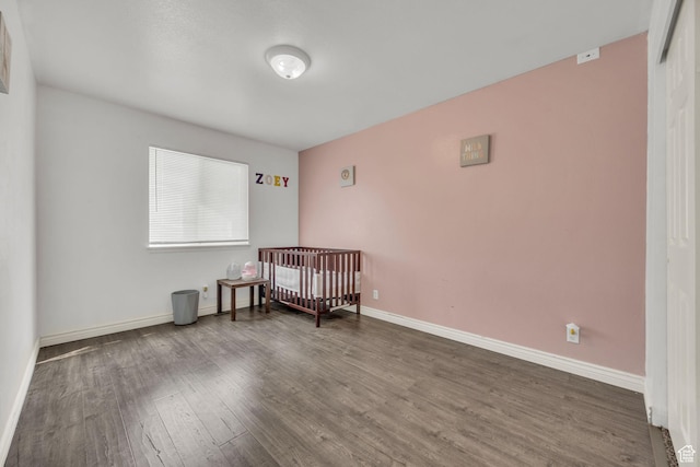 556 E 800 N, Ogden, UT 84404 - bedroom featuring wood finished floors, baseboards, and a crib